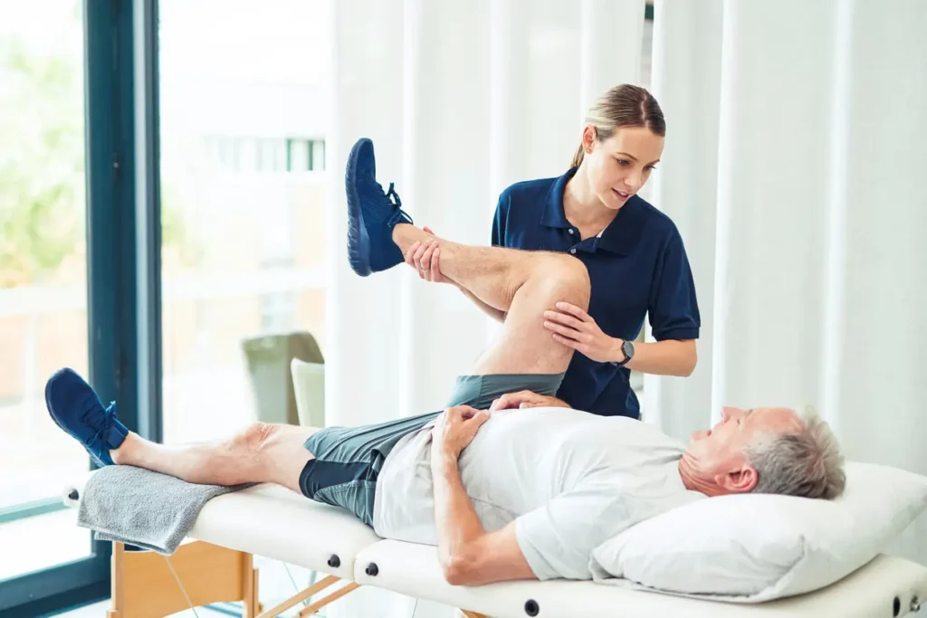 Physiotherapist assisting a patient with muscle recovery exercises Arundel