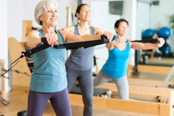 older woman doing weight training Arundel and resistance in the gym to tone upper arms